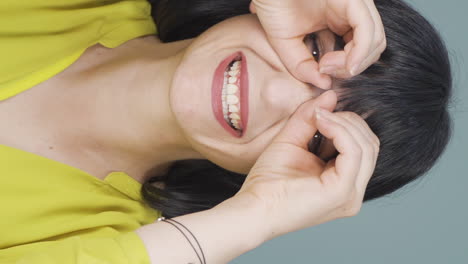 Vertical-video-of-Woman-with-binoculars-looking-away.